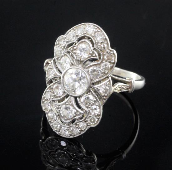 An attractive early 20th century French platinum and diamond cluster upfinger dress ring, size Q.